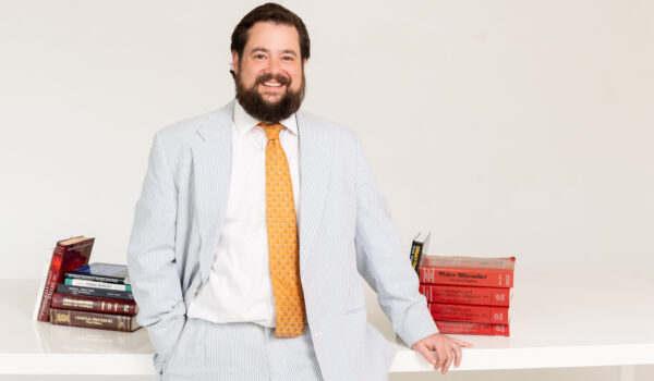 daniel kent standing next to desk