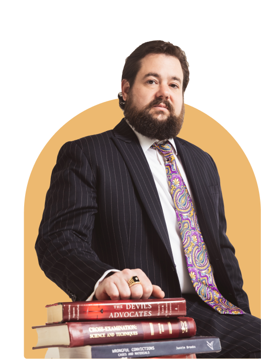 daniel kent lawyer standing with books