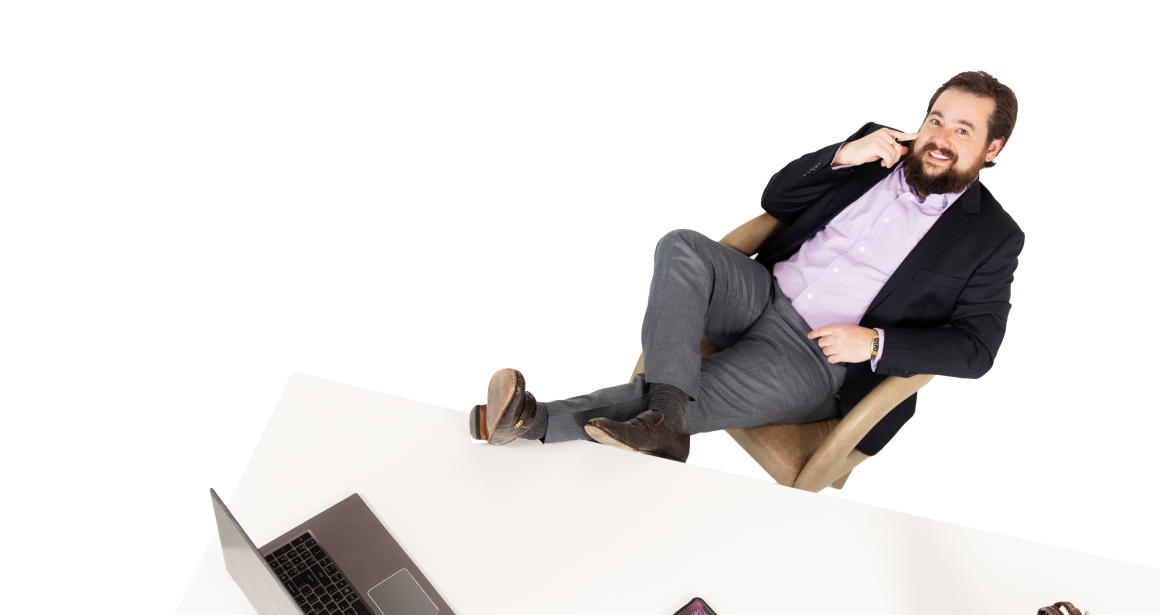 daniel kent seated with feet on desk