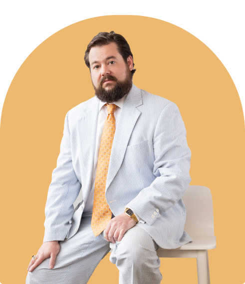 daniel kent seated with gold background